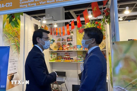 Cục trưởng Phát triển Thương mại và kinh tế Hong Kong Khâu Đằng Hoa (trái) và Tổng Lãnh sự Việt Nam tại Hong Kong Phạm Bình Đàm tại gian hàng trưng bày của Việt Nam. (Ảnh: Lê Anh/TTXVN)