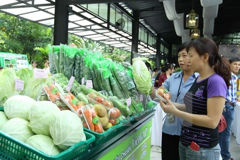 Người tiêu dùng lựa chọn sản phẩm rau an toàn tại siêu thị. (Ảnh: Thanh Vũ/TTXVN)