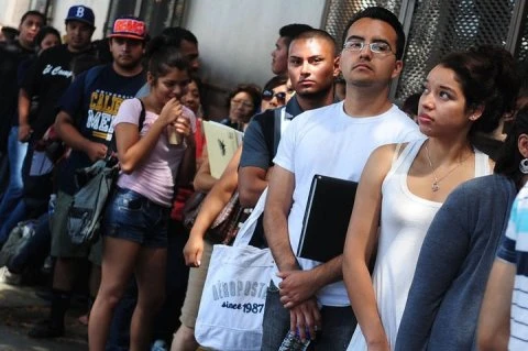 Người nhập cư xếp hàng dài chờ vào làm thủ tục (Nguồn: AFP)