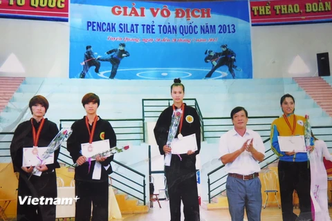 Vận động viên Trần Thị Thêm đứng trên bục cao nhất tại giải vô địch Pencak Silat trẻ toàn quốc năm 2013. (Ảnh: Phan Quân/Vietnam+)