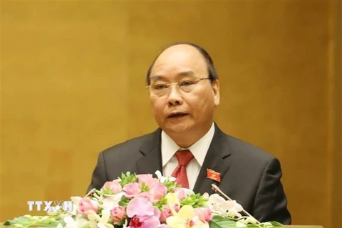 Thủ tướng Chính phủ Nguyễn Xuân Phúc trình bày Báo cáo. (Ảnh: Thống Nhất/TTXVN)