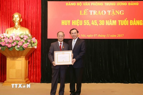 Ông Nguyễn Văn Nên trao huy hiệu 55 năm tuổi Đảng cho ông Phan Diễn, nguyên Ủy viên Bộ Chính trị khóa VIII và IX. (Ảnh: Phương Hoa/TTXVN)