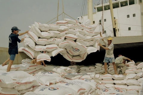 Bốc xếp gạo xuất khẩu tại cảng Sài Gòn. (Ảnh: Đình Huệ/ TTXVN)