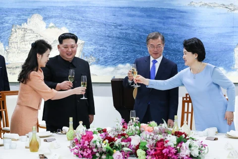 Nhà lãnh đạo Triều Tiên Kim Jong-un (thứ 2, trái) cùng phu nhân Ri Sol Ju, Tổng thống Hàn Quốc Moon Jae-in (thứ 2, phải) cùng phu nhân Kim Jung-sook (thứ nhất, phải) dự tiệc mừng tại làng đình chiến Panmunjom ngày 27/4. (Nguồn: Yonhap/TTXVN)