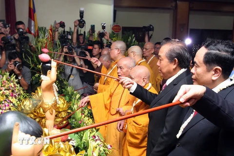 Phó Thủ tướng Trương Hòa Bình, các hòa thượng, Thượng tọa và các đại biểu thưc hiện nghi Lễ tắm Phật tại Lễ mừng Phật đản. (Ảnh: Nguyễn Dân/TTXVN)