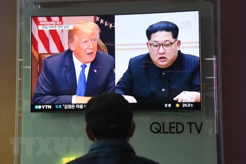 Người dân theo dõi truyền hình đưa tin về Tổng thống Mỹ Donald Trump (trái) và Nhà lãnh đạo Triều Tiên Kim Jong-un, tại nhà ga Seoul ngày 25/5. (Ảnh: AFP/TTXVN)