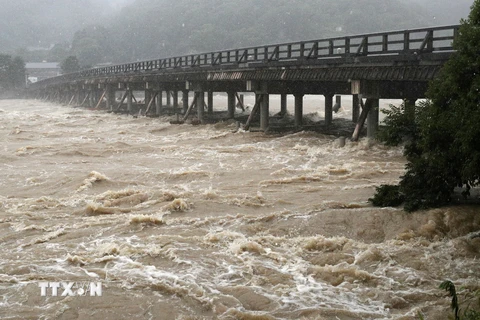 Nước lũ chảy xiết dưới cầu Togetsukyo ở Kyoto, miền Tây Nhật Bản ngày 6/7. (Nguồn: EPA/ TTXVN)