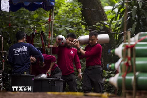 Binh sỹ Thái Lan chuyển các bình ôxy vào hang Tham Luang trong chiến dịch giải cứu các thành viên đội bóng ngày 7/7. (Ảnh: AFP/TTXVN)