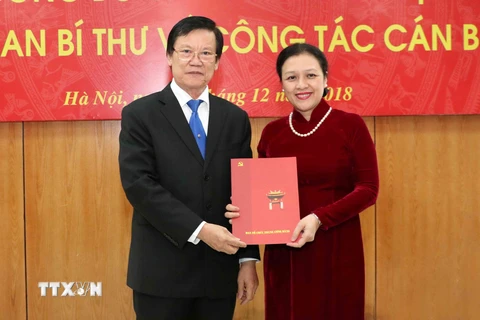 Phó Trưởng Ban Tổ chức Trung ương Hà Ban trao Quyết định của Ban Bí thư Trung ương Đảng cho bà Nguyễn Phương Nga. (Ảnh: Văn Điệp/TTXVN)