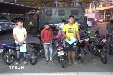 Những chiếc xe môtô và các đối tượng tham gia đua xe bị tạm giữ. (Ảnh: Nguyễn Văn Việt/TTXVN)