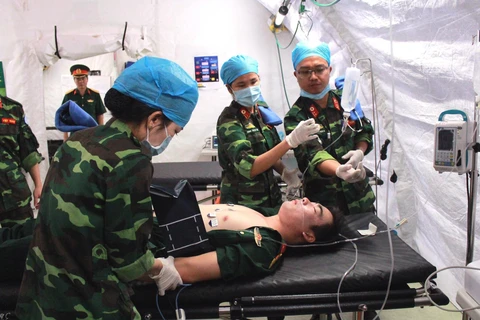 Các cán bộ, sỹ quan Bệnh viện dã chiến cấp 2 diễn tập xử lý tình huống. (Ảnh: Nguyễn Xuân Khu/TTXVN)