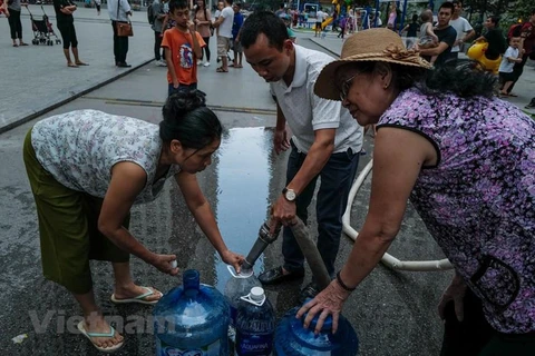 Người dân lấy nước sạch về sử dụng. (Nguồn: Vietnam+)