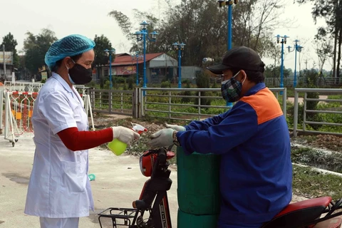 Nhân viên y tế xịt dung dịch sát khuẩn phòng chống dịch ở Sơn Lôi, Bình Xuyên, Vĩnh Phúc. (Ảnh: Hoàng Hùng/TTXVN)