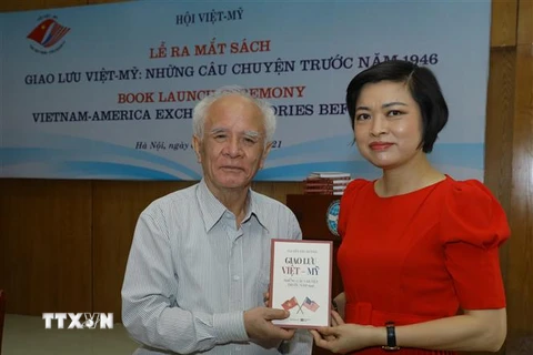 Ông Nguyễn Văn Huỳnh, tác giả cuốn sách 'Giao lưu Việt-Mỹ: Những câu chuyện trước năm 1946' tặng sách cho các đại biểu. (Ảnh: Văn Điệp/TTXVN)
