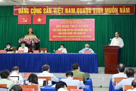 Chủ tịch nước Nguyễn Xuân Phúc trình bày chương trình hành động động tại điểm cầu xã Phước Thạnh, huyện Củ Chi. (Ảnh: Thống Nhất/TTXVN)
