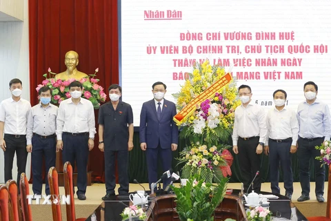 Chủ tịch Quốc hội Vương Đình Huệ tặng hoa chúc mừng Báo Nhân Dân. (Ảnh: Doãn Tấn/TTXVN)