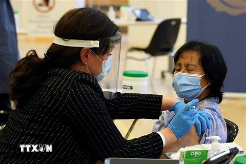 Nhân viên y tế tiêm vaccine Pfizer/BioNTech ngừa COVID-19 cho người dân tại Toronto, Canada. (Ảnh: AFP/TTXVN)