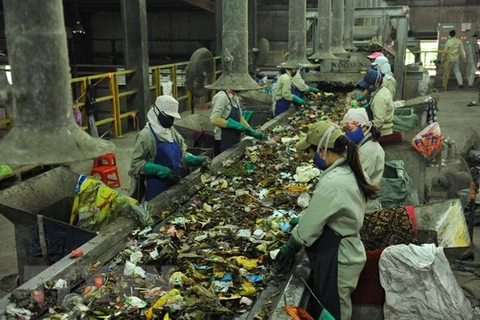 Công nhân Nhà máy xử lý chất thải rắn phân loại rác hữu cơ để sản xuất phân vi sinh. (Ảnh: Minh Đức/TTXVN)