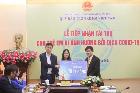 Đại diện Vinamilk (đứng giữa) và VTV Digital cùng trao bảng tượng trưng 10 tỷ đồng cho đại diện Quỹ Bảo trợ trẻ em Việt Nam. (Nguồn: Vietnam+)