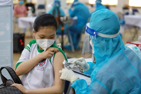 Nhân viên y tế tiêm vaccine phòng COVID-19 cho học sinh tại huyện Củ Chi. (Ảnh: Thu Hương/TTXVN)