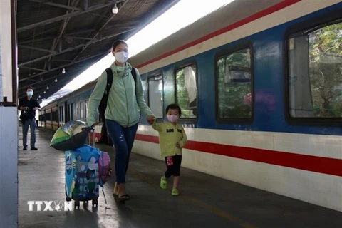 Hành khách lên tàu về quê đón Tết tại ga Sài Gòn sáng 20/1. (Ảnh: Tiến Lực/TTXVN)