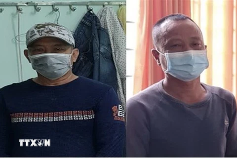Bị can Nguyễn Văn Nhơn (bên trái) và Huỳnh Văn Lấm bị khởi tố, bắt giam về hành vi 'Chống người thi hành công vụ.' (Ảnh: TTXVN phát)