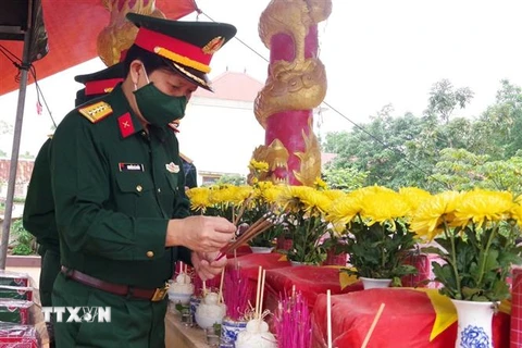 Đoàn lãnh đạo Bộ Chỉ huy Quân sự tỉnh Quảng Trị dâng hương các hài cốt liệt sỹ được quàn tại Nhà bia ghi danh liệt sỹ xã Vĩnh Sơn. (Ảnh: Nguyên Lý/TTXVN)