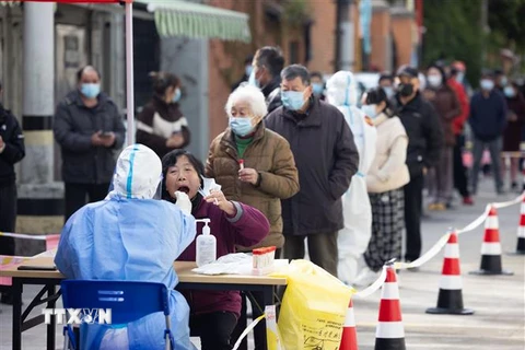 Nhân viên y tế lấy mẫu xét nghiệm COVID-19 cho người dân tại Thượng Hải, Trung Quốc. (Ảnh: THX/TTXVN)