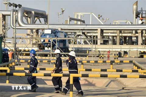 Công nhân làm việc tại nhà máy chế biến dầu thô Abqaiq thuộc Tập đoàn năng lượng quốc doanh Saudi Aramco của Saudi Arabia. (Ảnh: AFP/TTXVN)