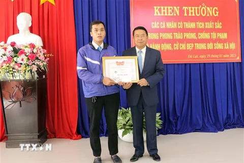 Chủ tịch Ủy ban Nhân dân thành phố Đà Lạt Tôn Thiện San tặng giấy khen cho tài xế taxi Nguyễn Duy Phin. (Ảnh: Quốc Hùng/TTXVN)