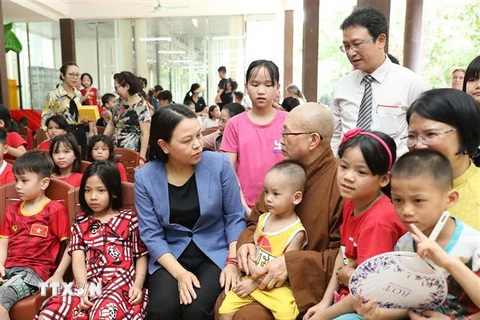Phó Chủ tịch-Tổng Thư ký Ủy ban Trung ương Mặt trận Tổ quốc Việt Nam Nguyễn Thị Thu Hà thăm hỏi trẻ mồ côi tại chùa. (Ảnh: Minh Đức/TTXVN)