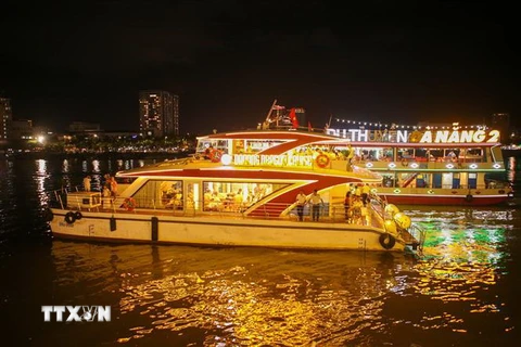 Các du thuyền đưa khách du lịch thưởng ngoạn cảnh đẹp trên sông Hàn về đêm và ngắm pháo hoa. (Ảnh: Trần Lê Lâm/TTXVN)
