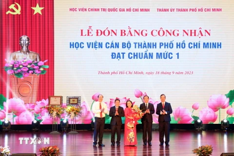 Giám đốc Học viện Chính trị Quốc gia Hồ Chí Minh Nguyễn Xuân Thắng trao Bằng công nhận đạt chuẩn mức 1 cho Học viện Cán bộ Thành phố Hồ Chí Minh. (Ảnh: Tiến Lực/TTXVN)