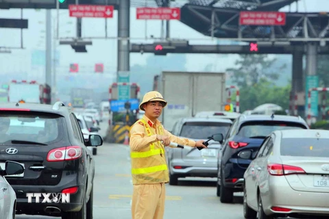 Lực lượng cảnh sát giao thông điều tiết, phân luồng giao thông. (Ảnh: Phạm Kiên/TTXVN)