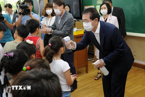Kiểm tra thân nhiệt cho học sinh để phòng tránh lây nhiễm MERS ở thủ đô Seoul ngày 17/6. (Nguồn: THX/TTXVN)
