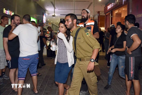 Cảnh sát Israel sơ tán người dân tại trạm xe buýt sau vụ tấn công. (Nguồn: AFP/TTXVN)