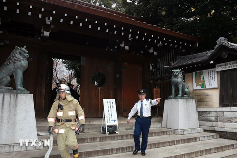 Cảnh sát và nhân viên cứu hỏa làm nhiệm vụ tại hiện trường vụ nổ ở đền Yasukuni ngày 23/11. (Nguồn: AFP/TTXVN)