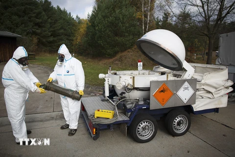 Các nhân viên trong trang phục bảo hộ diễn tập tại khu vực tiêu hủy vũ khí hóa học của Syria tại Munster, miền Bắc nước Đức ngày 30/10/2013. (AFP/TTXVN)