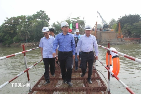 Bộ trưởng Bộ Giao thông Vận tải Trương Quang Nghĩa (giữa) và đoàn công tác kiểm tra công trình xây dựng cầu Ghềnh mới. (Ảnh: Sỹ Tuyên/TTXVN)