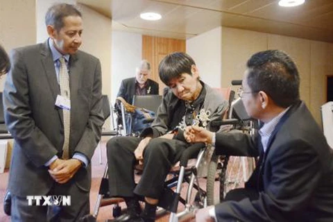 Các quan chức Chính phủ Indonesia thăm hỏi Shinobu Sakamoto (giữa), một bệnh nhân bị nhiễm độc thủy ngân người Nhật Bản, tại Geneva, Thụy Sĩ ngày 27/9. (Nguồn: Kyodo/TTXVN)