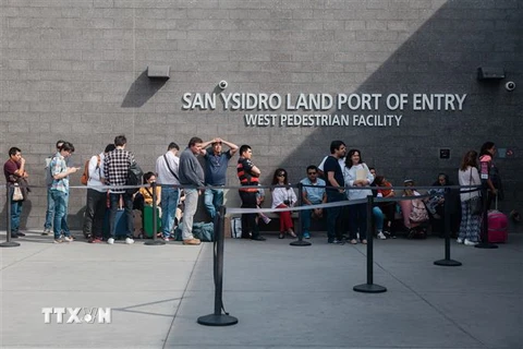 Người dân xếp hàng tại cửa khẩu biên giới San Ysidro giữa San Diego, California (Mỹ) và Tijuana (Mexico) ngày 28/10/2018. (Ảnh: AFP/TTXVN)