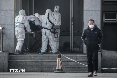 Chuyển bệnh nhân nghi nhiễm virus tại bệnh viện Jinyintan ở thành phố Vũ Hán, Trung Quốc ngày 18/1/2020. (Ảnh: AFP/TTXVN)