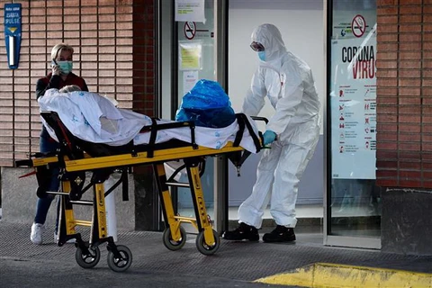 Nhân viên y tế chuyển bệnh nhân nhiễm COVID-19 vào bệnh viện Severo Ochoa ở Leganes, Tây Ban Nha. (Ảnh: AFP/TTXVN)