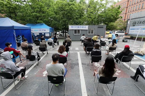 Người dân xếp hàng chờ xét nghiệm COVID-19 tại Seoul, Hàn Quốc ngày 12/5/2020. (Ảnh: Yonhap/TTXVN)
