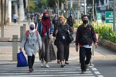 Người dân đeo khẩu trang phòng lây nhiễm COVID-19 tại Jakarta, Indonesia. (Ảnh: THX/TTXVN)
