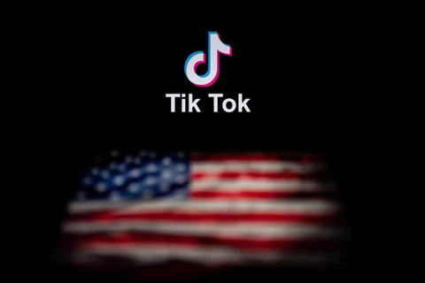 Biểu tượng TikTok và quốc kỳ Mỹ trên màn hình máy tính ở Bắc Kinh, Trung Quốc. (Ảnh: AFP/TTXVN)