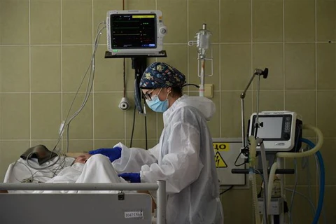 Nhân viên y tế điều trị cho bệnh nhân COVID-19 tại bệnh viện ở Lviv, Ukraine. (Ảnh: AFP/TTXVN)