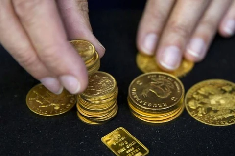 Giá vàng giao ngay tại châu Á giảm trong khi đồng USD yếu đi