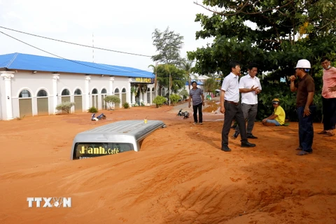 Lãnh đạo thành phố Phan Thiết có mặt tại hiện trường chỉ đạo khắc phục khẩn trương sự cố cát tràn. (Ảnh: Nguyễn Thanh/TTXVN)