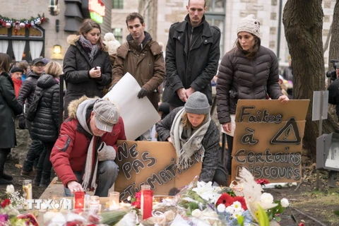 Người dân Canada thắp nến tưởng niệm các nạn nhân vụ tấn công khủng bố ở Pháp bên ngoài Lãnh sự quán Pháp ở thành phố Quebec. 
